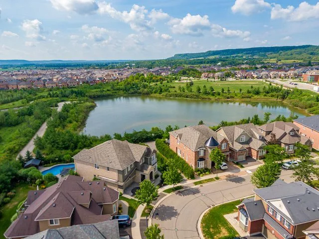 Milton homes beside a pond, green space and the Niagara Escarpment
